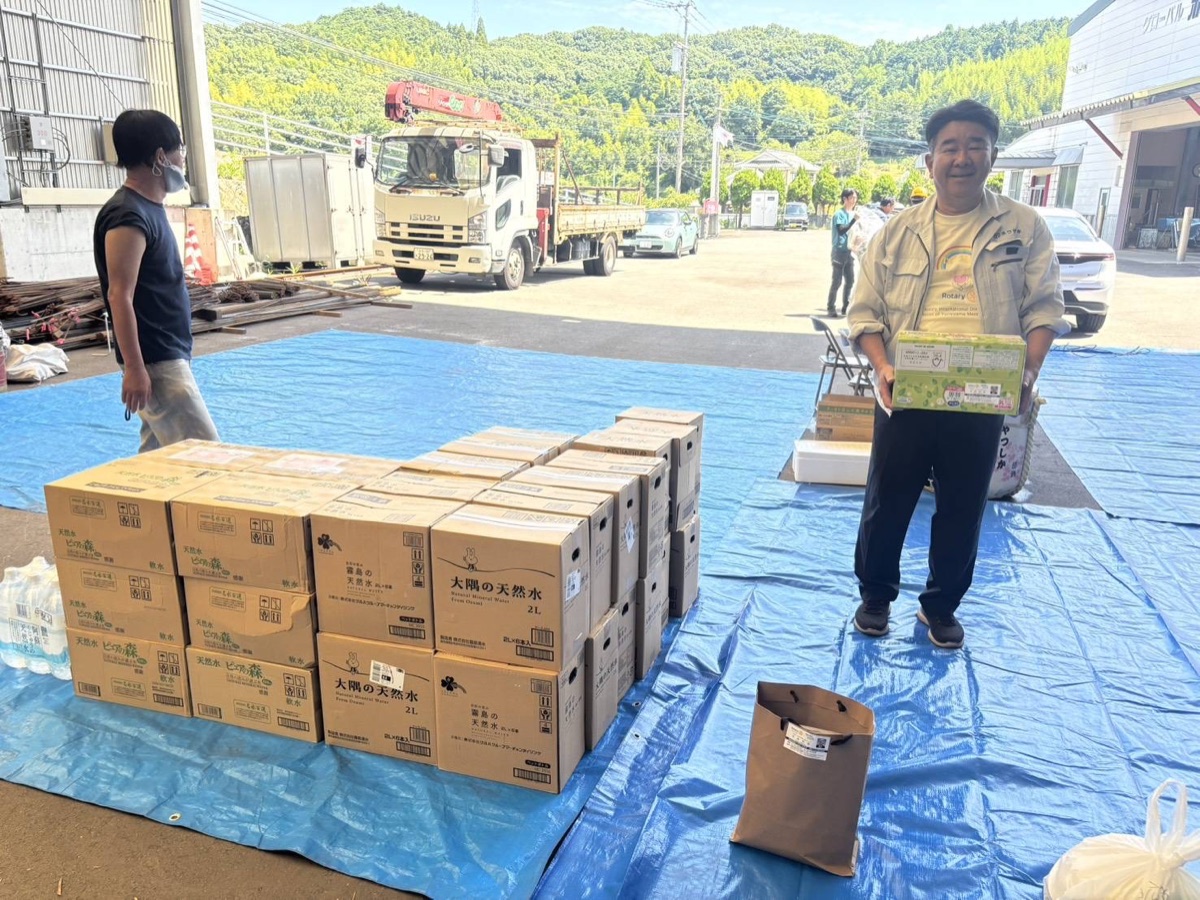 熊本県八代市の支援物資受入場所で、飲料水の箱を手にする株式会社ゴタール代表